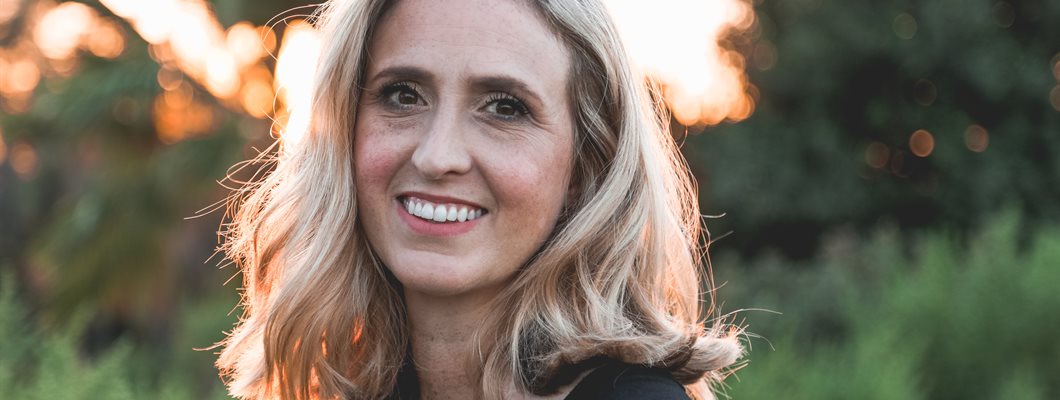 An older lady photographed smiling in nature