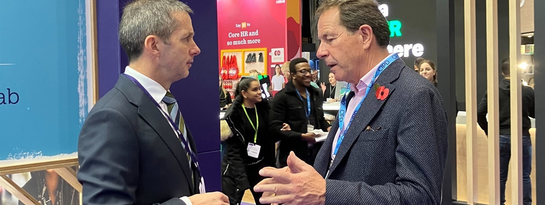 A picture of the CIPD's Chief Executive, Peter Cheese talking to a man at the CIPD's Annual Conference and Exhibition in Manchester.