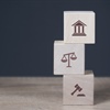 Three stacking blocks with employment law icons printed on them